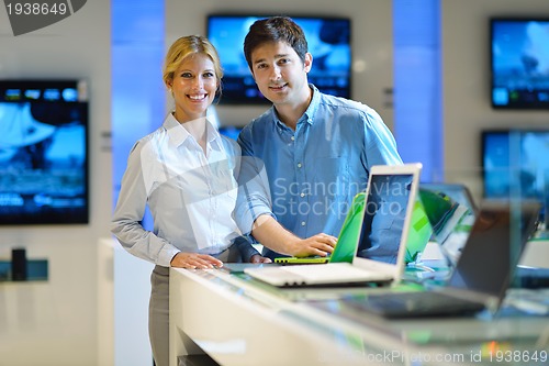 Image of Young couple in consumer electronics store