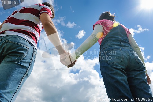 Image of Portrait of romantic young couple smiling together outdoor