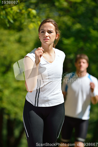 Image of Young couple jogging at morning