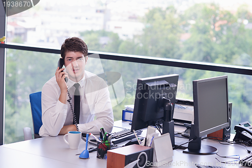 Image of happy young business man at office