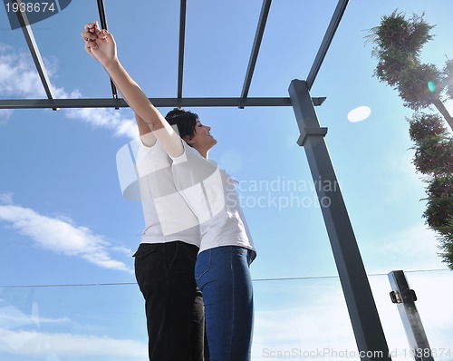 Image of couple relaxing on balcony