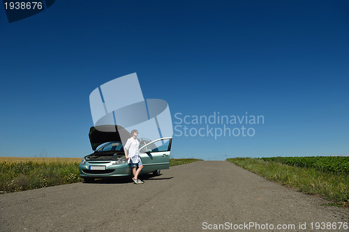 Image of woman with broken car