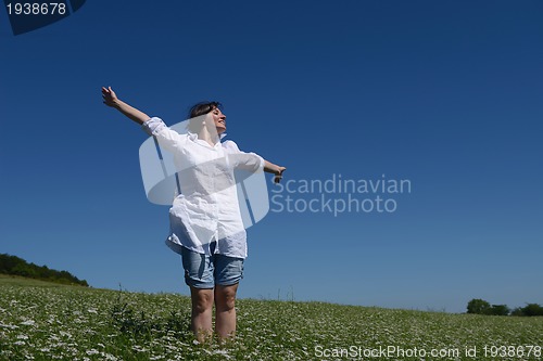 Image of Young happy woman in green field
