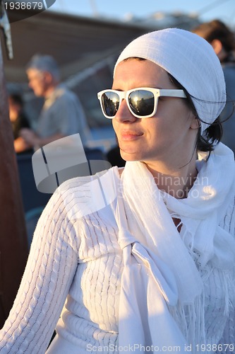 Image of Greek woman on the streets of Oia, Santorini, Greece