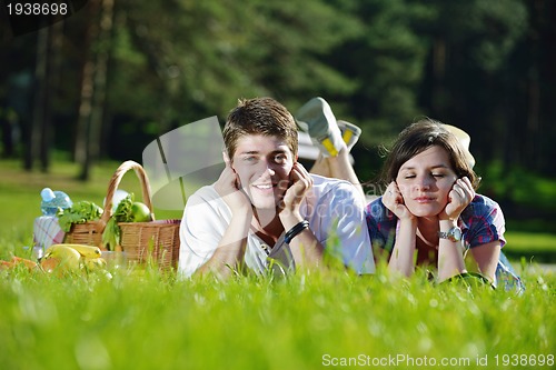 Image of happy young couple having a picnic outdoor