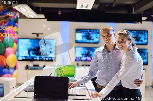 Image of Young couple in consumer electronics store