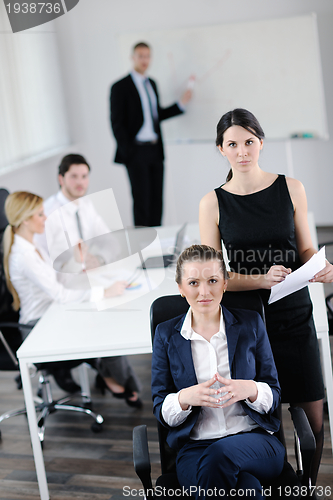 Image of business woman with her staff in background