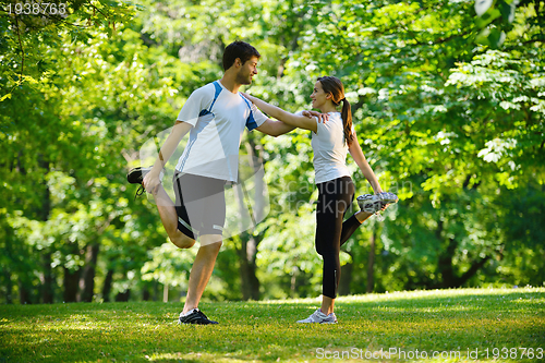 Image of Couple doing stretching exercise  after jogging