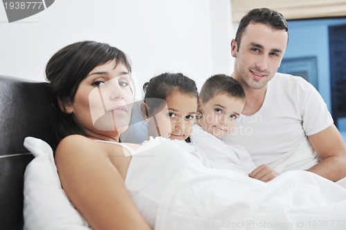 Image of happy young Family in their bedroom