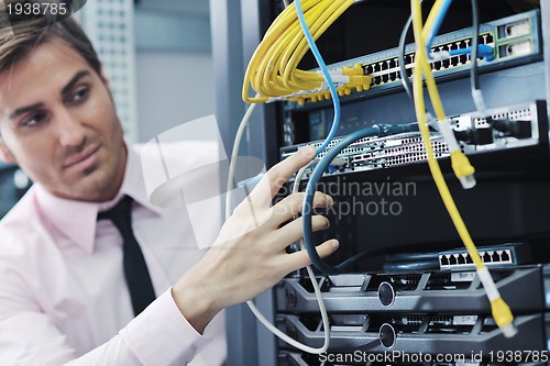 Image of young it engeneer in datacenter server room