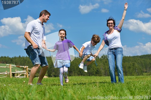 Image of happy young family have fun outdoors