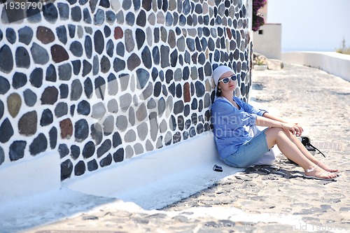 Image of Greek woman on the streets of Oia, Santorini, Greece