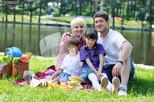 Image of Happy family playing together in a picnic outdoors