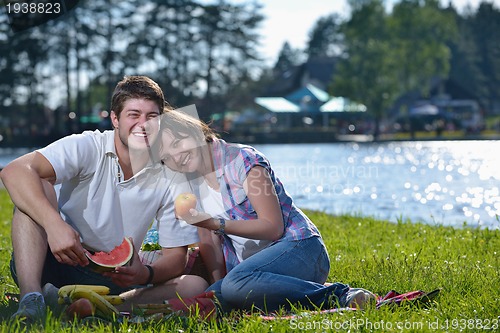 Image of happy young couple having a picnic outdoor