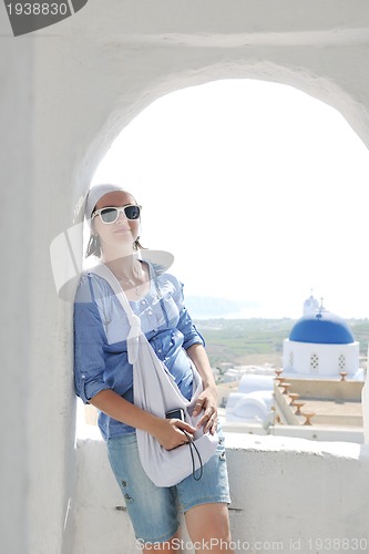 Image of Greek woman on the streets of Oia, Santorini, Greece