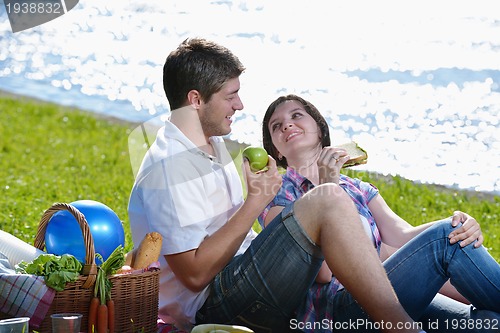 Image of happy young couple having a picnic outdoor
