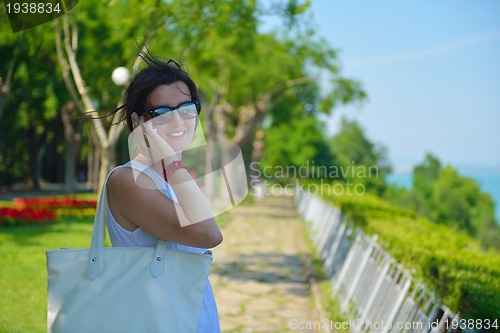 Image of young business woman using mobile phone outdoor