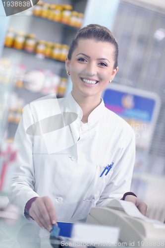 Image of pharmacist chemist woman standing in pharmacy drugstore