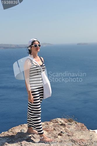 Image of Greek woman on the streets of Oia, Santorini, Greece