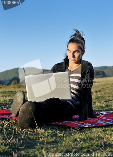 Image of young teen girl work on laptop outdoor