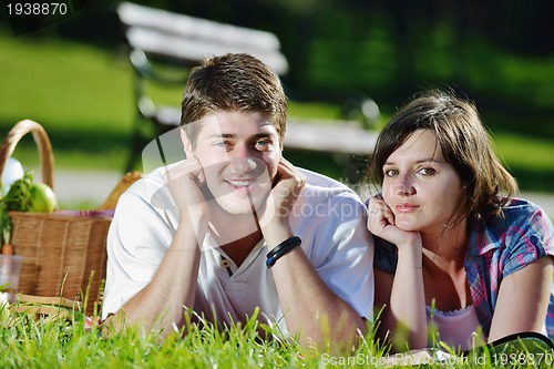 Image of happy young couple having a picnic outdoor