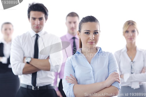 Image of business woman standing with her staff in background