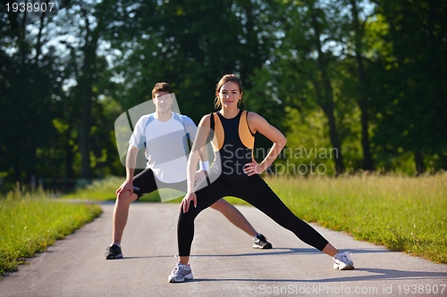 Image of Couple doing stretching exercise  after jogging