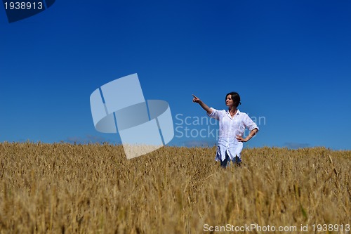 Image of young woman in wheat field at summer