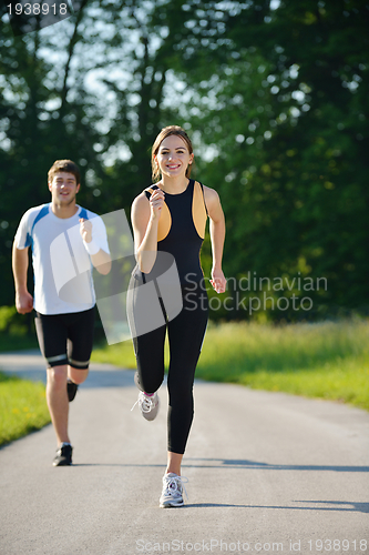 Image of Young couple jogging at morning