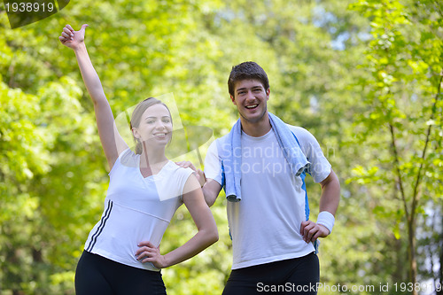 Image of Couple doing stretching exercise  after jogging