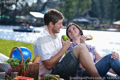 Image of happy young couple having a picnic outdoor