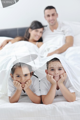 Image of happy young Family in their bedroom