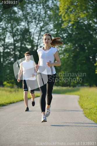 Image of Young couple jogging at morning