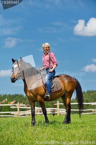 Image of happy woman  on  horse