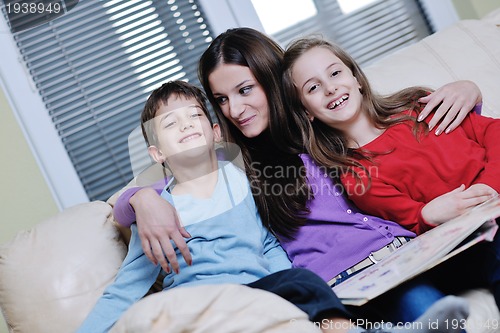 Image of young mom play with their kids at home and reading book