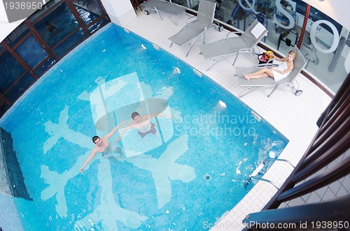 Image of young people group at spa swimming pool