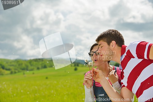 Image of Portrait of romantic young couple smiling together outdoor