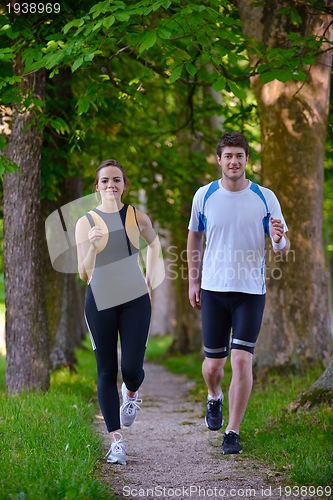 Image of Young couple jogging