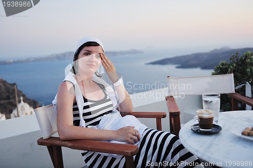 Image of Greek woman on the streets of Oia, Santorini, Greece