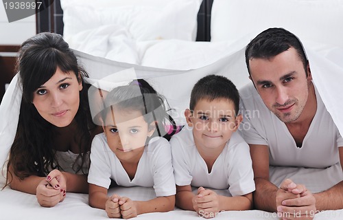 Image of happy young Family in their bedroom