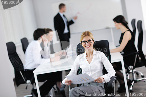 Image of business woman with her staff in background