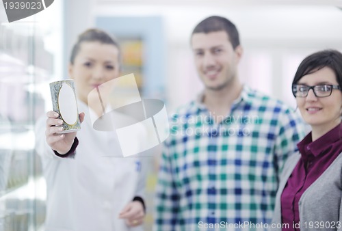 Image of pharmacist suggesting medical drug to buyer in pharmacy drugstor