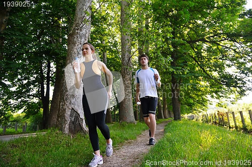 Image of Young couple jogging