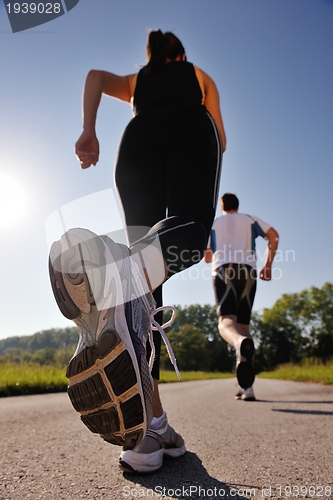 Image of Young couple jogging