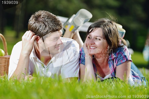 Image of happy young couple having a picnic outdoor