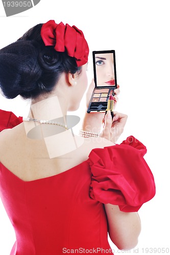 Image of beautiful young woman applying makeup