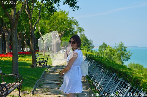 Image of young business woman using mobile phone outdoor
