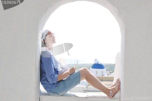 Image of Greek woman on the streets of Oia, Santorini, Greece