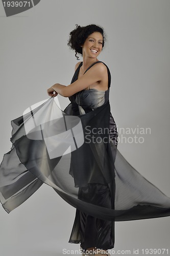Image of elegant woman in fashionable dress posing in the studio