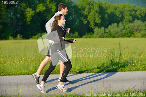 Image of Young couple jogging